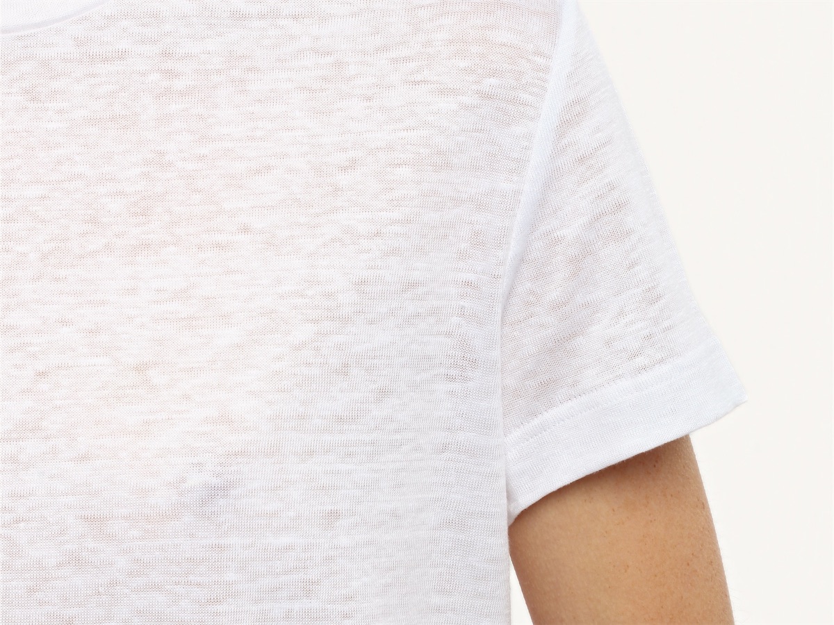 The white linen knit at the shoulder and the sleeve, close up.